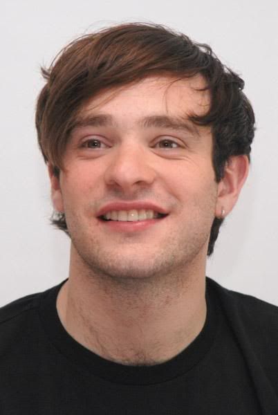 Side swept bangs hairstyle from Charlie Cox. 