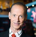 Photo of John Waters with pencil thin mustache.