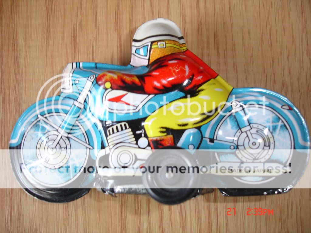 This is a vintage tin toy friction system motorcycle.Made in Japan 